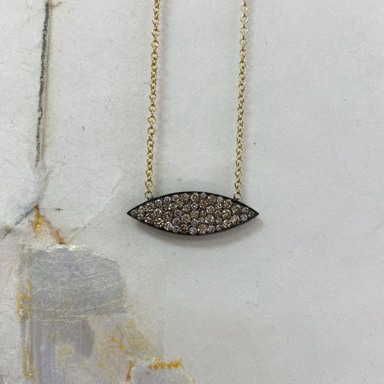 Photo of Kim Collins Champagne Zircon Marquise Necklace in a decorative scene, designed by , available at Plumb Gold & Plumb Silver