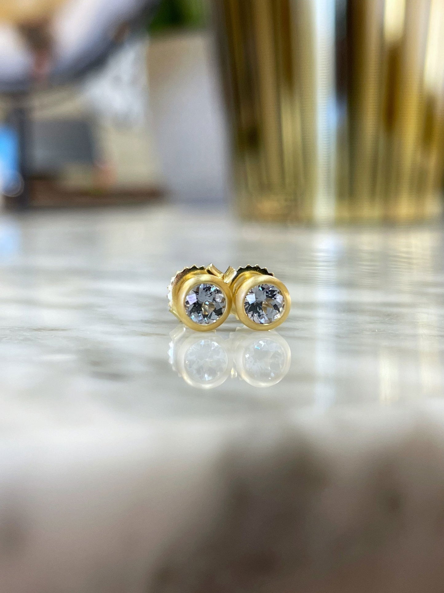 Photo of Kim Collins Grey Spinel Studs in a decorative scene, designed by , available at Plumb Gold & Plumb Silver