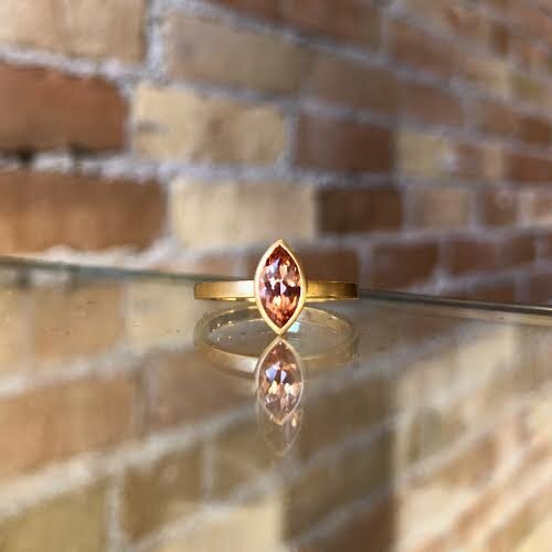 Photo of Kim Collins Peach Tourmaline Yum Drop in a decorative scene, designed by , available at Plumb Gold & Plumb Silver