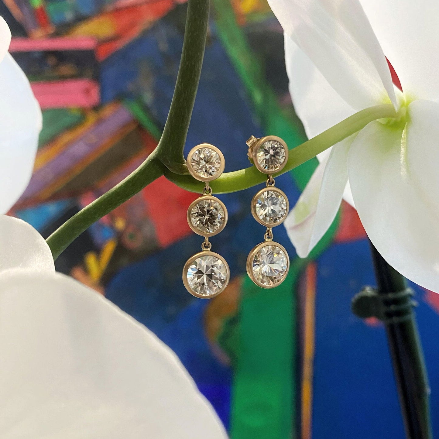 Photo of Kimberly Collins Champagne Zircon Triple Drop Earring in a decorative scene, designed by , available at Plumb Gold & Plumb Silver