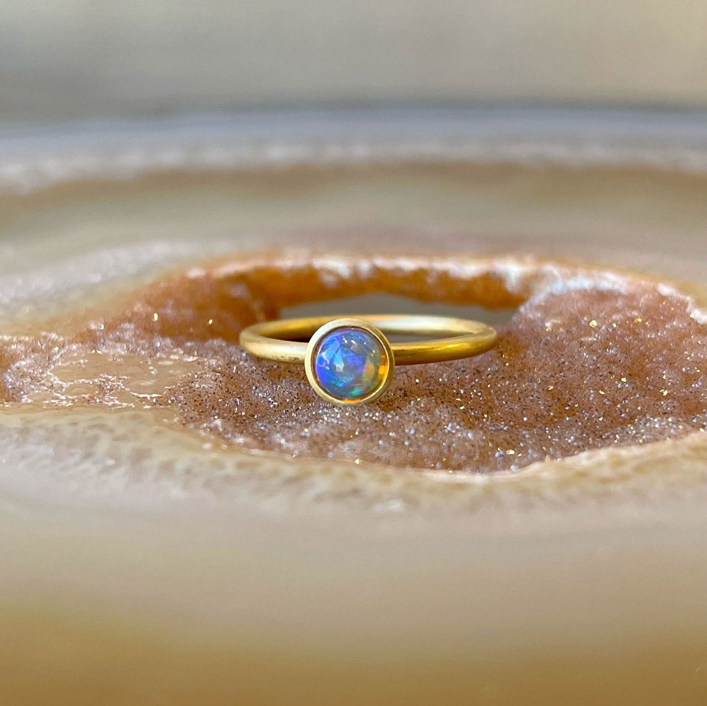 Photo of Kimberly Collins Ethiopian Yumdrop Ring in a decorative scene, designed by , available at Plumb Gold & Plumb Silver