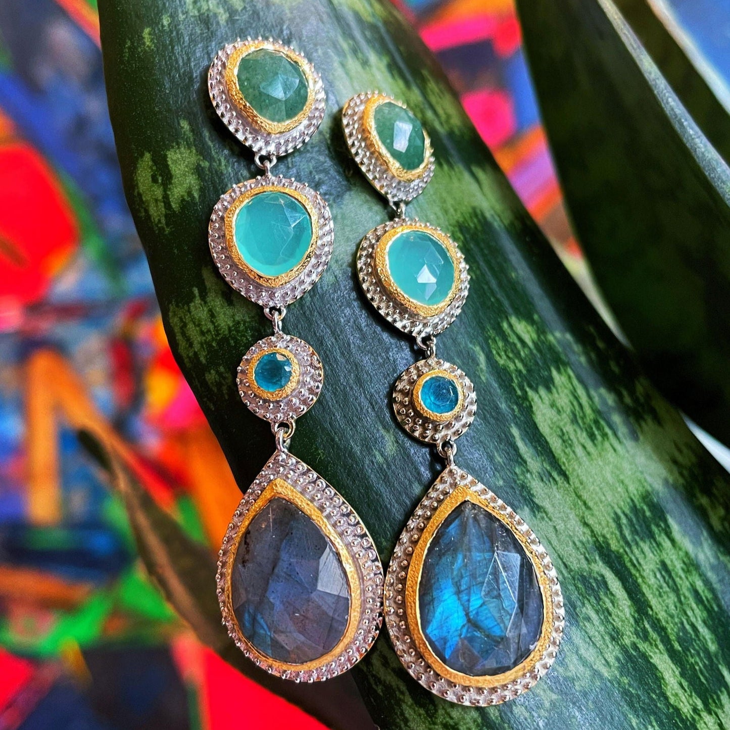 Photo of "Kira" Dangle Earrings in a decorative scene, designed by , available at Plumb Gold & Plumb Silver