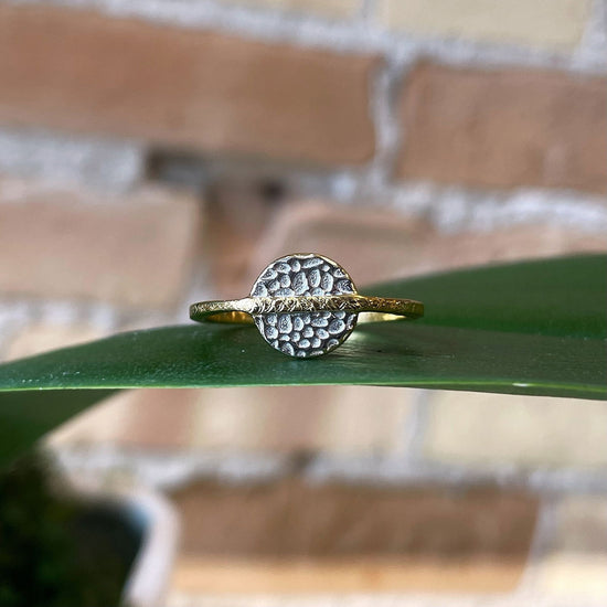 Load image into Gallery viewer, Photo of “Kymbal” Ring in a decorative scene, designed by , available at Plumb Gold &amp;amp; Plumb Silver
