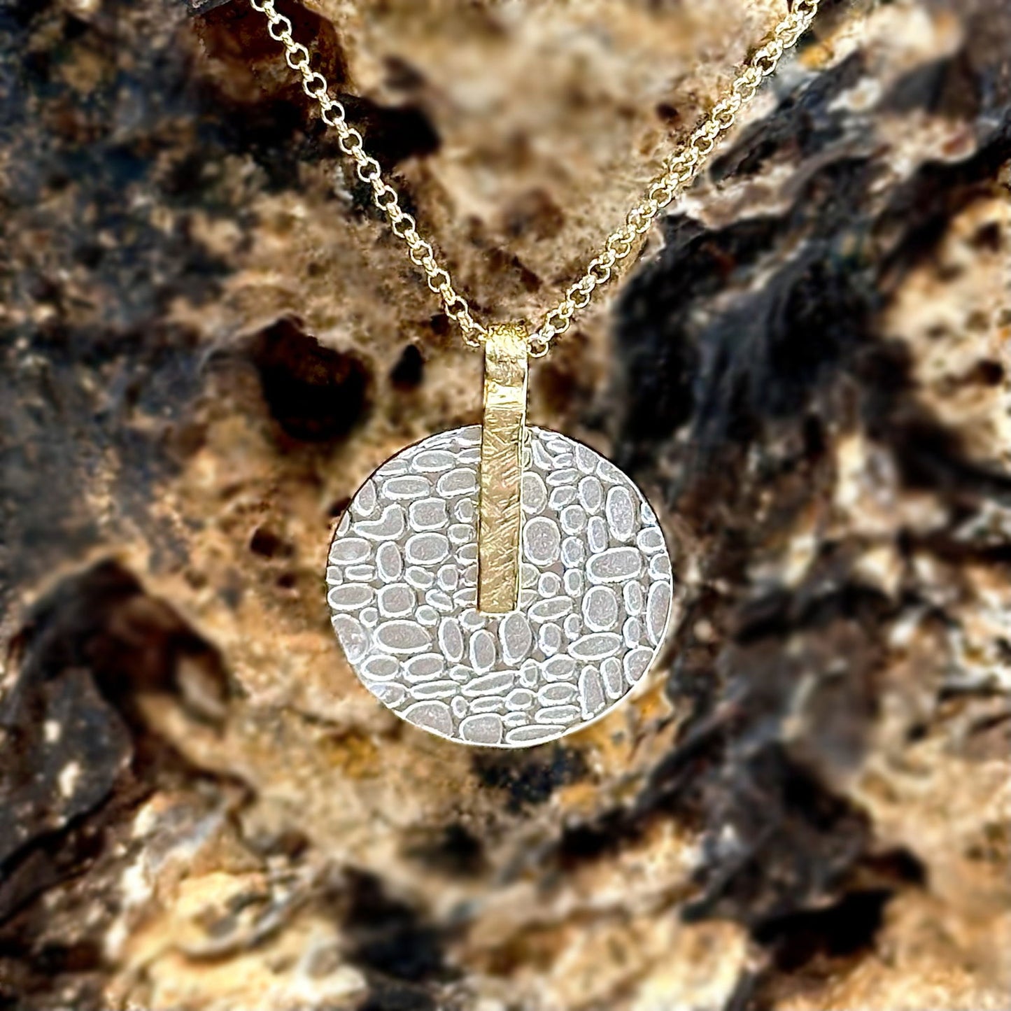 Photo of "Kymbal" pendant in a decorative scene, designed by -, available at Plumb Gold & Plumb Silver