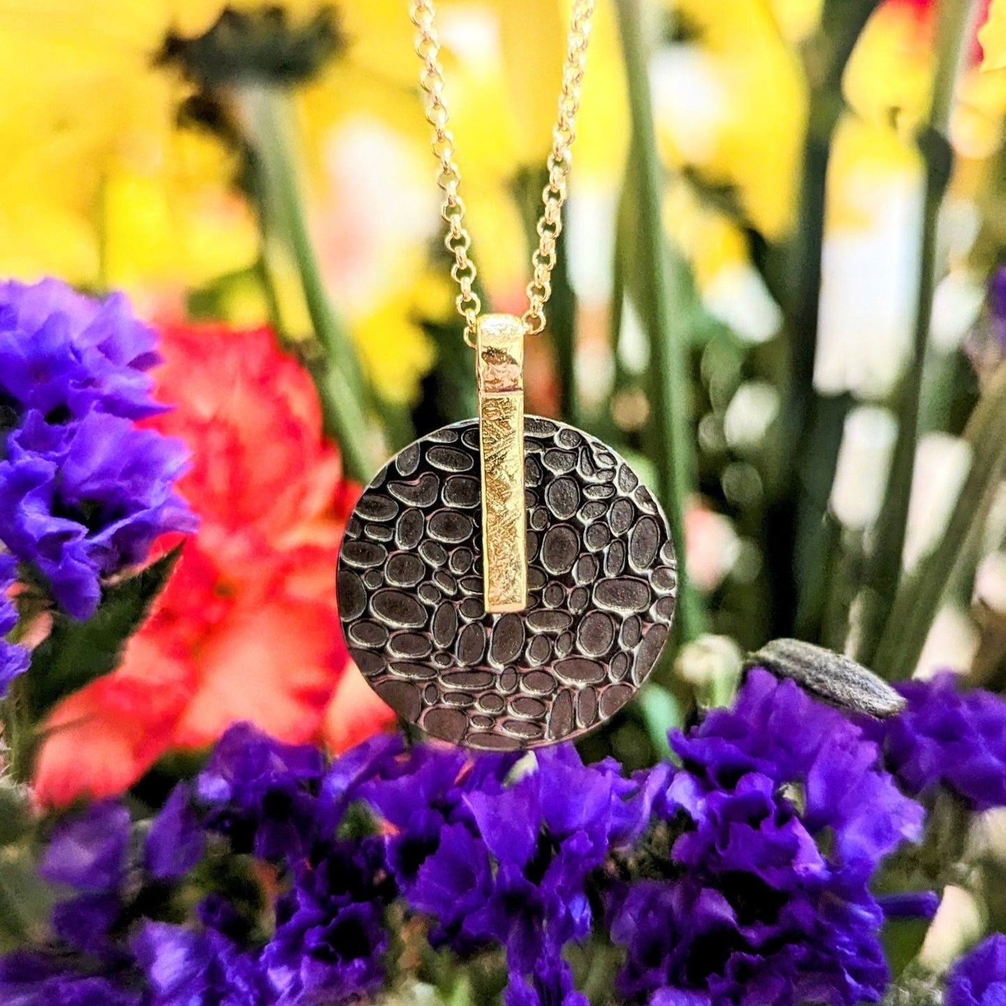 Photo of "Kymbal" pendant in a decorative scene, designed by , available at Plumb Gold & Plumb Silver