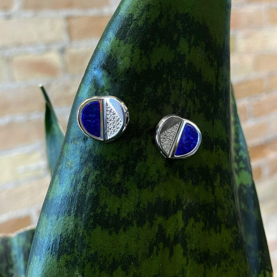Photo of Lapis and White Sapphire Folded Circle Stud Earrings in a decorative scene, designed by , available at Plumb Gold & Plumb Silver