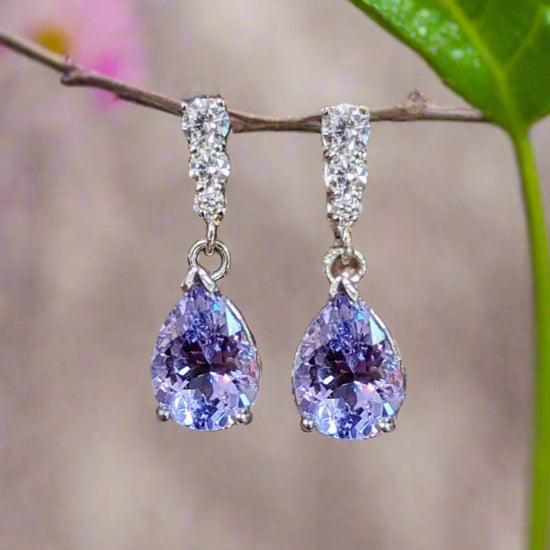 Photo of Lavender Spinel Diamond Accented Dangles in a decorative scene, designed by , available at Plumb Gold & Plumb Silver