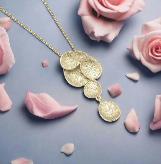 Photo of “Lily” Pendant in a decorative scene, designed by , available at Plumb Gold & Plumb Silver