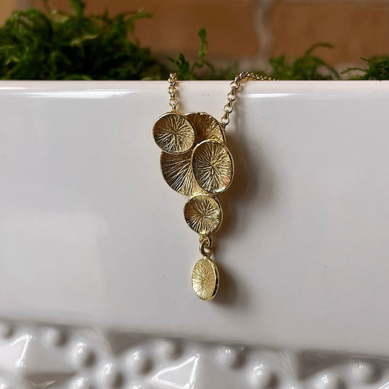 Photo of “Lily” Pendant in a decorative scene, designed by , available at Plumb Gold & Plumb Silver
