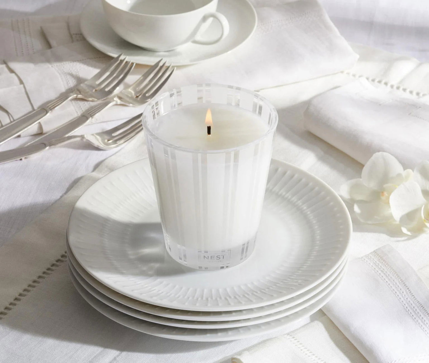 Photo of Linen Candle in a decorative scene, designed by , available at Plumb Gold & Plumb Silver