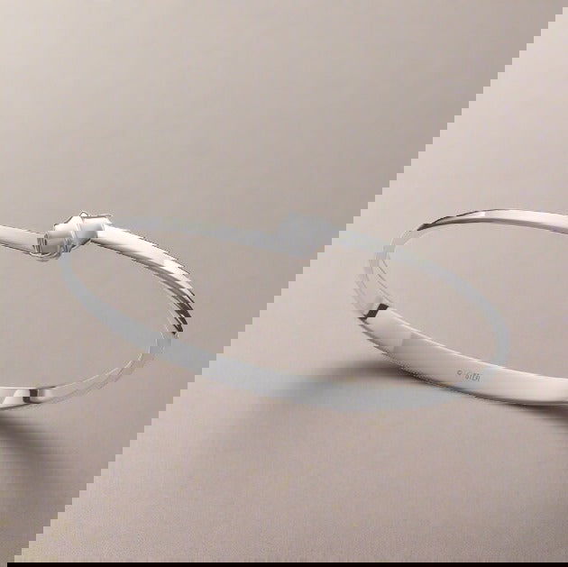 Photo of "Love Knot" Bracelet in a decorative scene, designed by , available at Plumb Gold & Plumb Silver
