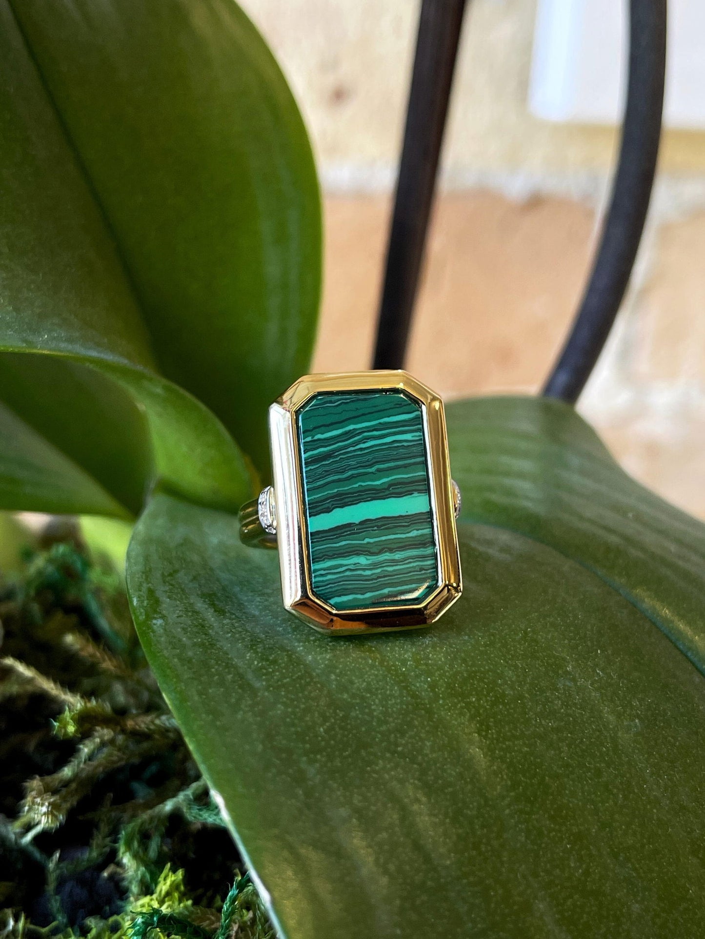 Photo of Malachite Fashion Ring in a decorative scene, designed by , available at Plumb Gold & Plumb Silver