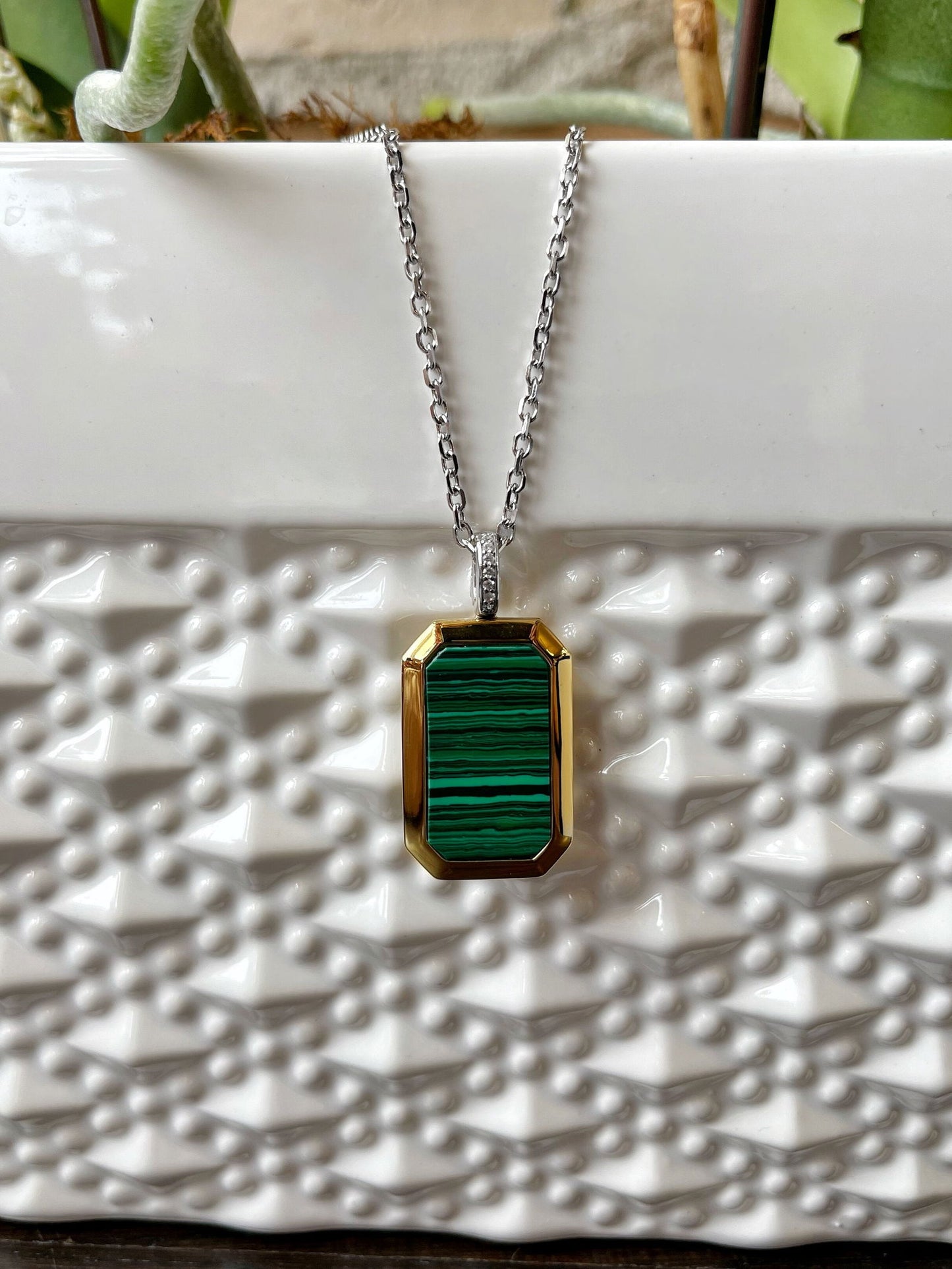 Photo of Malachite Locket in a decorative scene, designed by , available at Plumb Gold & Plumb Silver