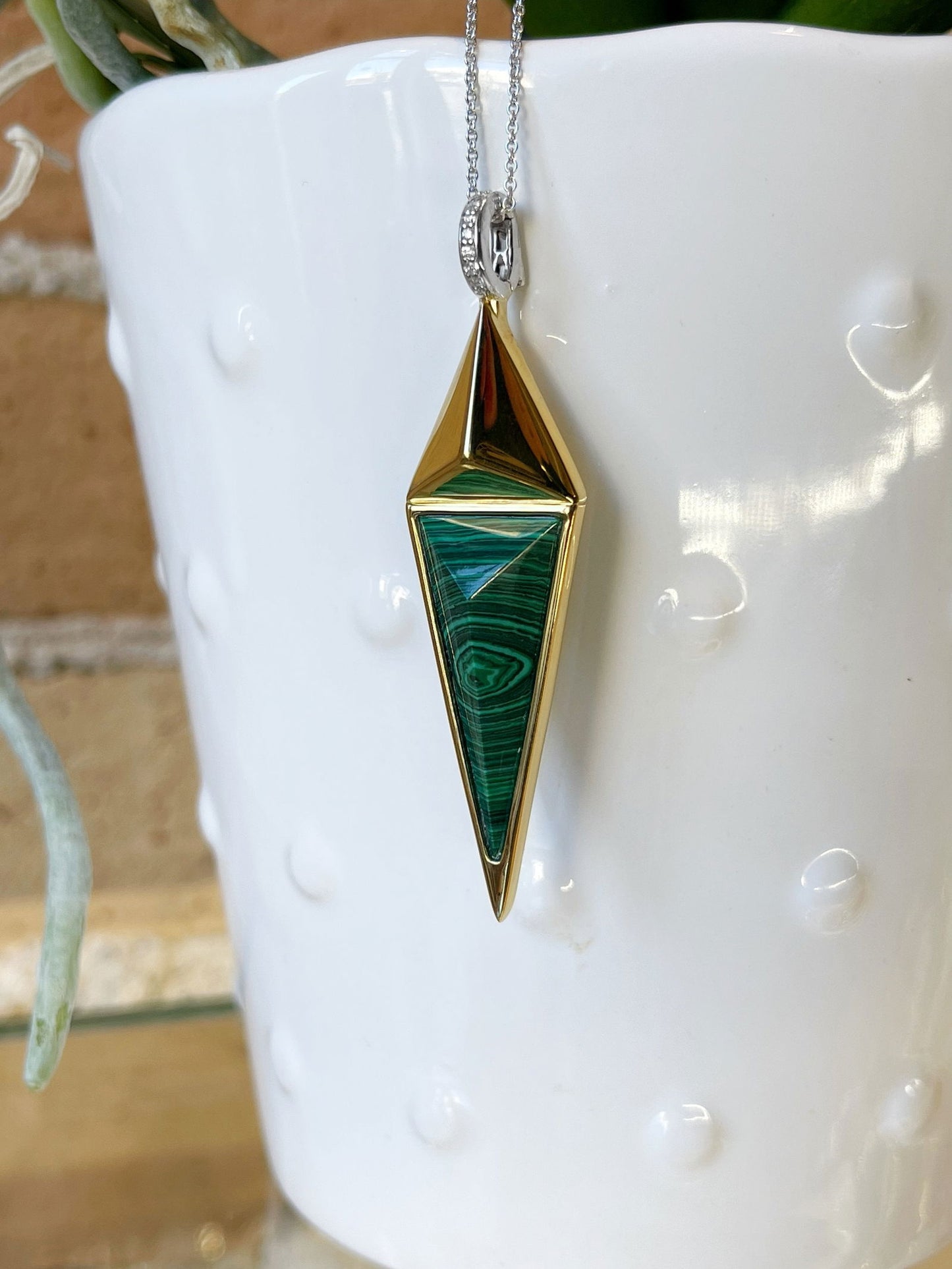 Photo of Malachite and Cubic Zirconia Necklace in a decorative scene, designed by , available at Plumb Gold & Plumb Silver