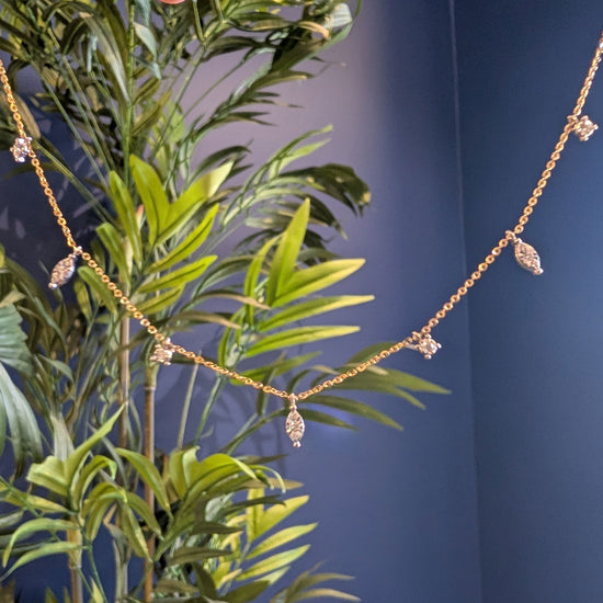 Photo of Marquesa Necklace in a decorative scene, designed by -, available at Plumb Gold & Plumb Silver