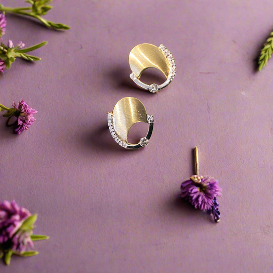 Photo of Matte crescent Oval Stud Earrings in a decorative scene, designed by , available at Plumb Gold & Plumb Silver