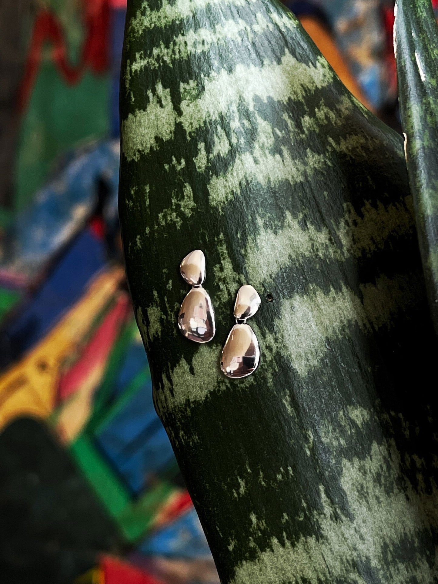 Photo of "Mercury" Drop Earrings in a decorative scene, designed by , available at Plumb Gold & Plumb Silver