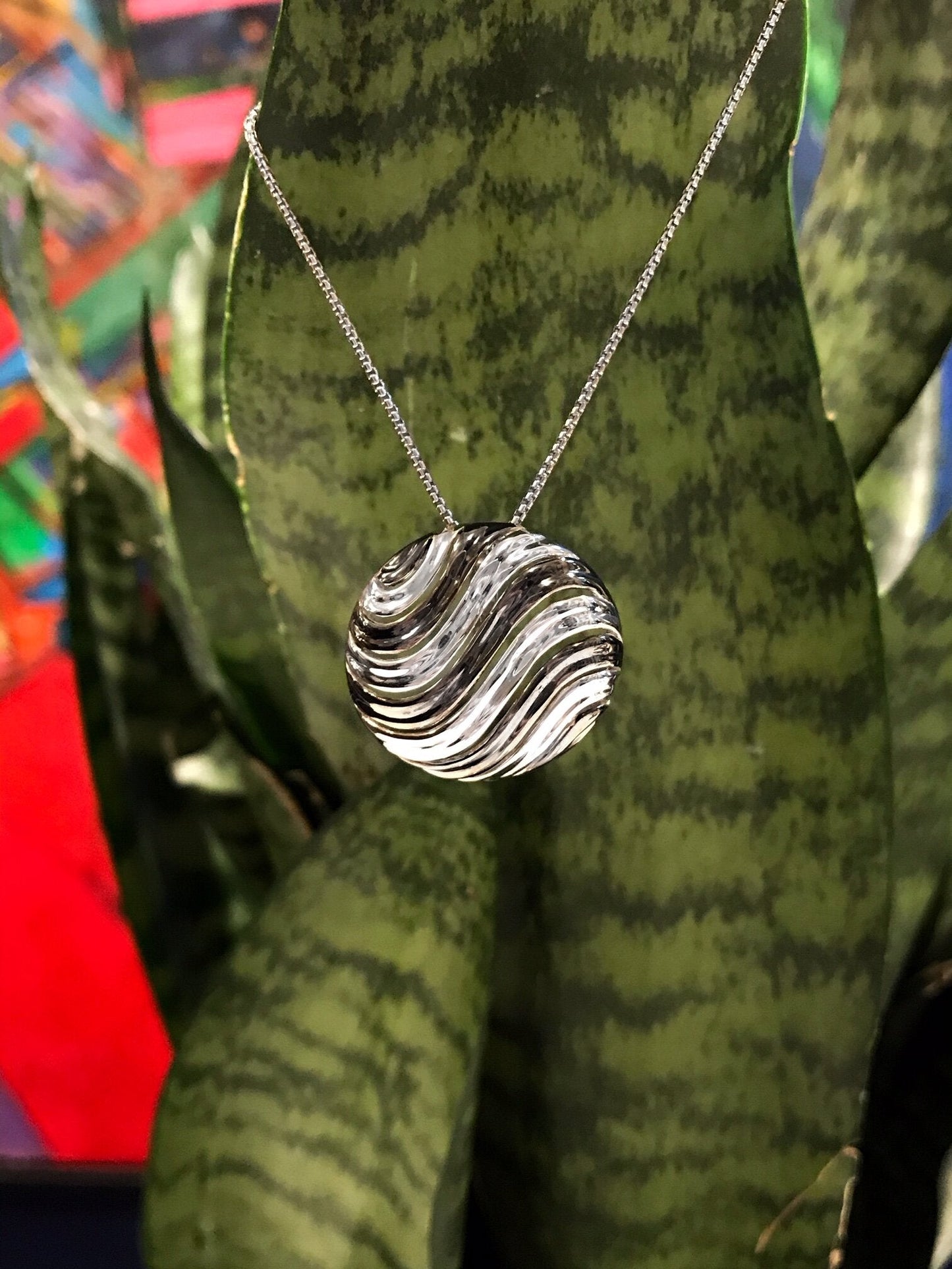 Photo of Mini "Bay" Pendant in a decorative scene, designed by , available at Plumb Gold & Plumb Silver