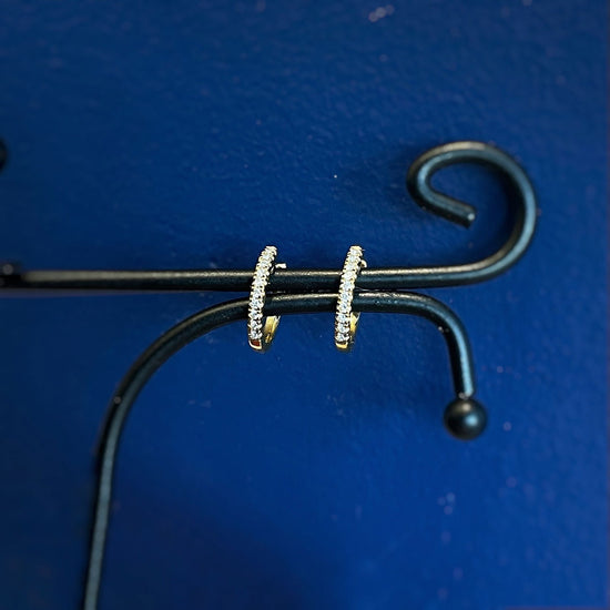 Photo of Mini Diamond Hoops in a decorative scene, designed by , available at Plumb Gold & Plumb Silver