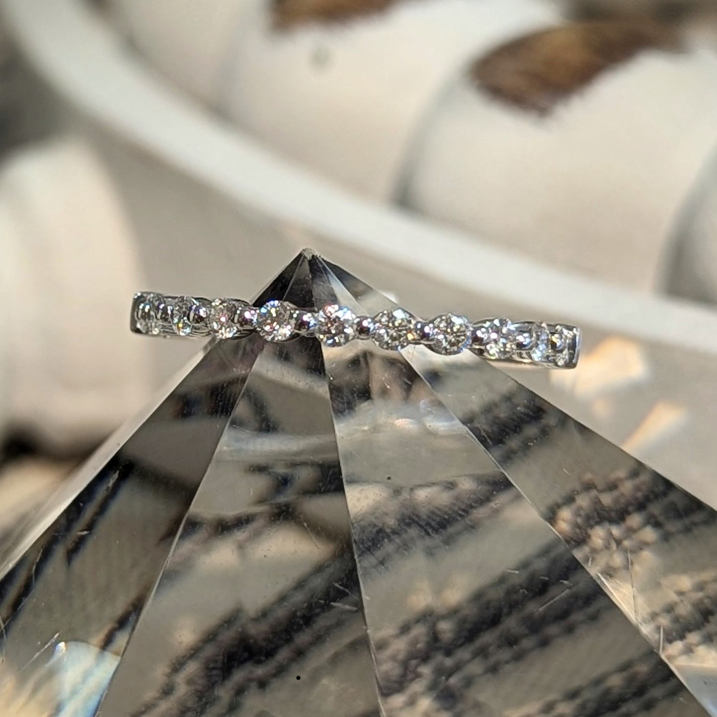 Photo of "Mira" band in a decorative scene, designed by , available at Plumb Gold & Plumb Silver