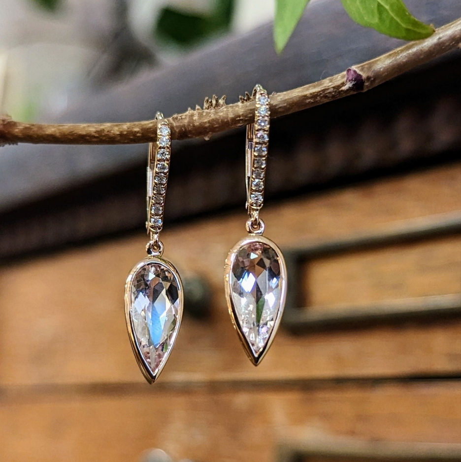 Photo of Morganite Bezel Dangle Earrings in a decorative scene, designed by -, available at Plumb Gold & Plumb Silver