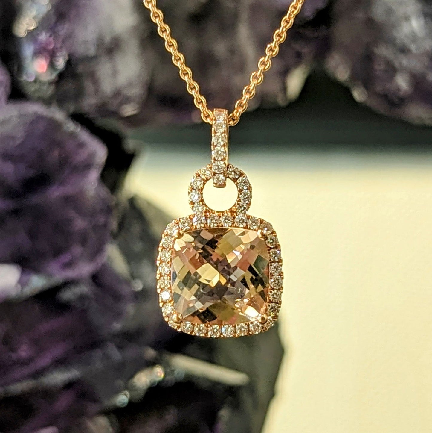 Photo of Morganite Halo Pendant in a decorative scene, designed by , available at Plumb Gold & Plumb Silver