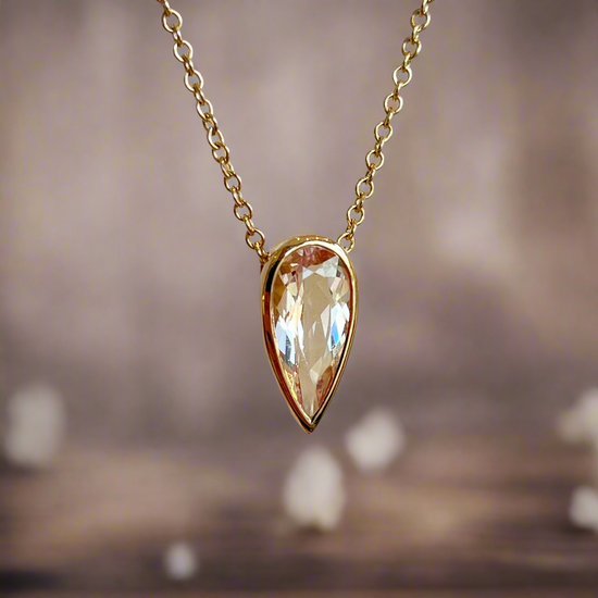 Photo of Morganite Necklace in a decorative scene, designed by , available at Plumb Gold & Plumb Silver