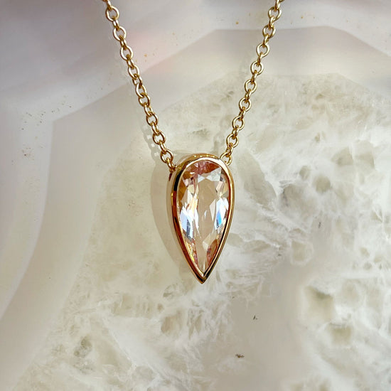Photo of Morganite Necklace in a decorative scene, designed by , available at Plumb Gold & Plumb Silver