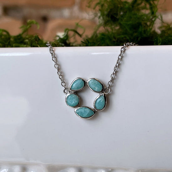 Photo of “Morning” Amazonite Necklace in a decorative scene, designed by , available at Plumb Gold & Plumb Silver