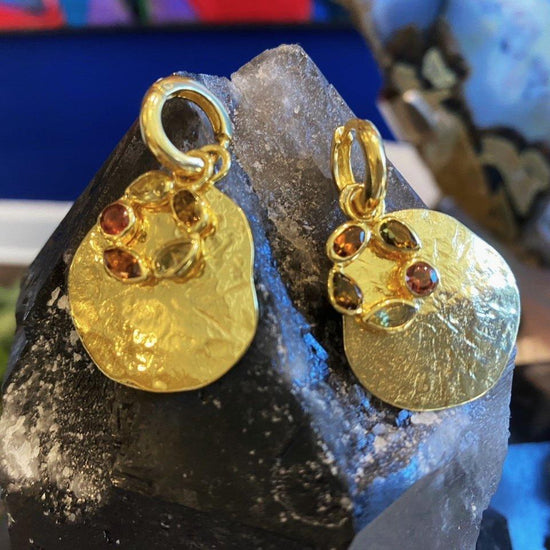 Photo of "Morning" Tourmaline Earrings in a decorative scene, designed by , available at Plumb Gold & Plumb Silver