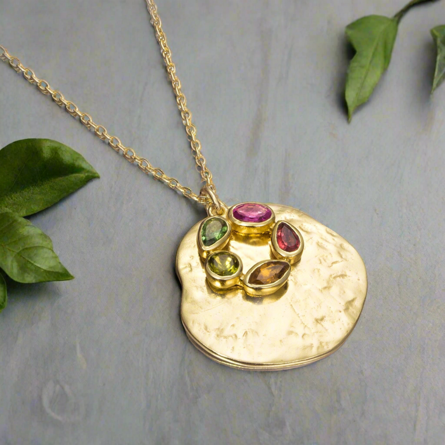 Photo of "Morning" Tourmaline Necklace in a decorative scene, designed by , available at Plumb Gold & Plumb Silver