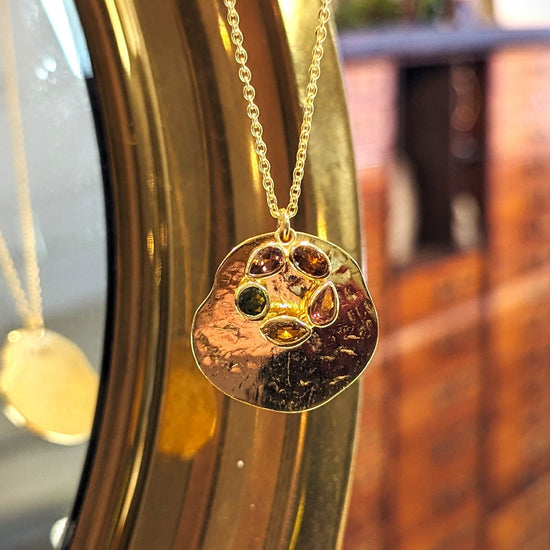 Photo of "Morning" Tourmaline Necklace in a decorative scene, designed by , available at Plumb Gold & Plumb Silver