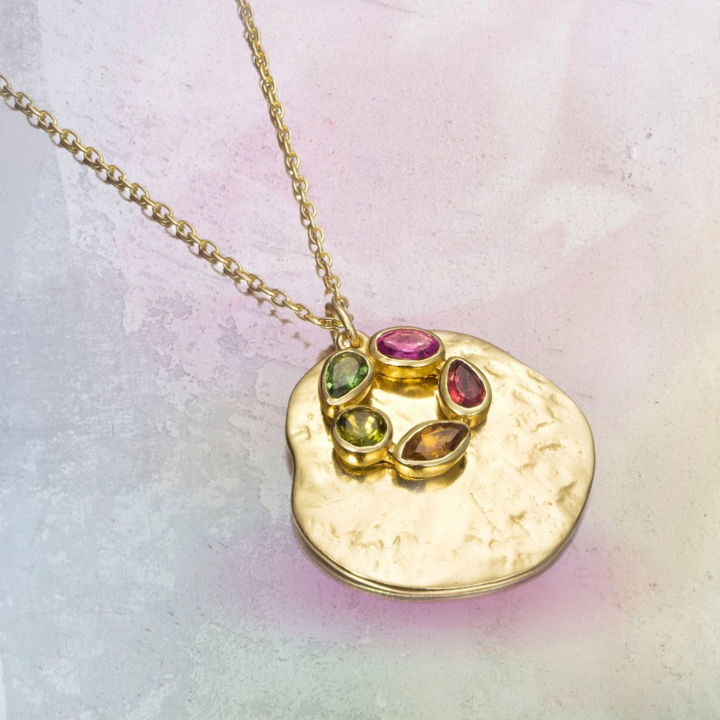 Photo of "Morning" Tourmaline Necklace in a decorative scene, designed by , available at Plumb Gold & Plumb Silver