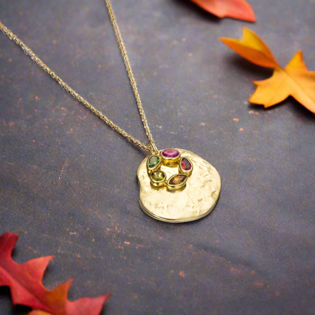 Photo of "Morning" Tourmaline Necklace in a decorative scene, designed by , available at Plumb Gold & Plumb Silver
