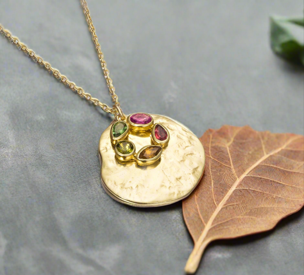 Photo of "Morning" Tourmaline Necklace in a decorative scene, designed by , available at Plumb Gold & Plumb Silver