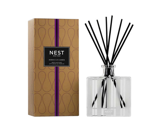 Photo of Moroccan Amber Reed Diffuser in a decorative scene, designed by , available at Plumb Gold & Plumb Silver