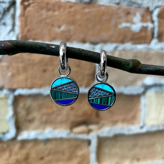 Photo of Multi-Stone Blue Cubic Zirconia Hoop Charms in a decorative scene, designed by , available at Plumb Gold & Plumb Silver
