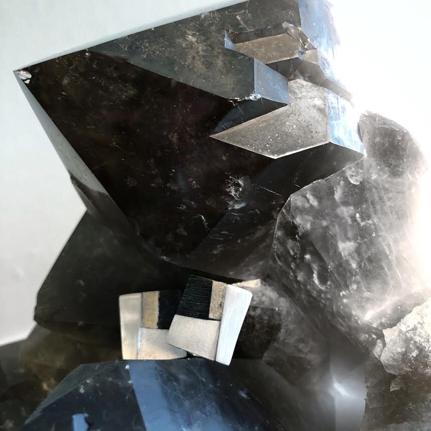 Photo of Multi-Textured Geometric Stud Earrings in a decorative scene, designed by , available at Plumb Gold & Plumb Silver