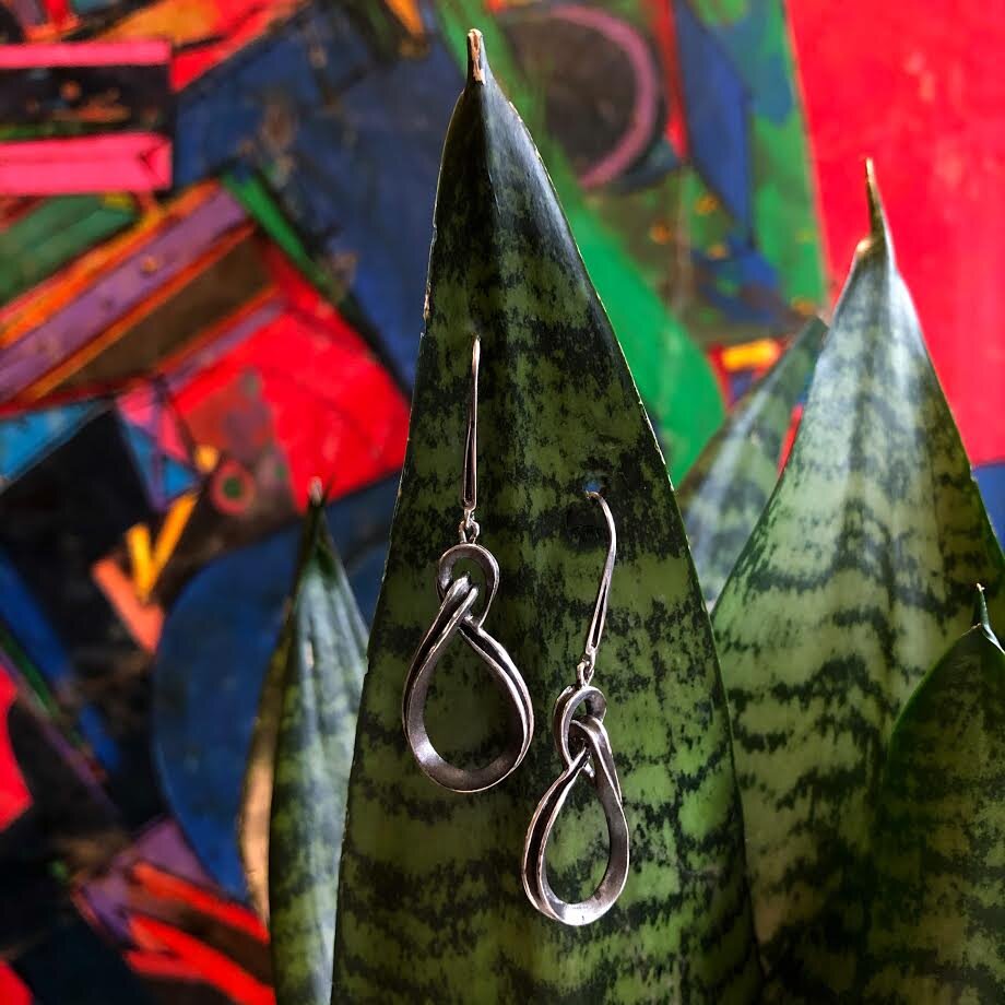 Photo of Nautical Knot Dangle Earring in a decorative scene, designed by , available at Plumb Gold & Plumb Silver