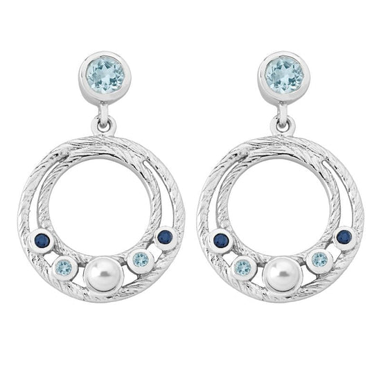 Photo of Ocean Dangle Earrings in a decorative scene, designed by , available at Plumb Gold & Plumb Silver