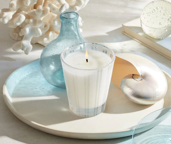 Photo of Ocean Mist & Sea Salt Candle in a decorative scene, designed by , available at Plumb Gold & Plumb Silver