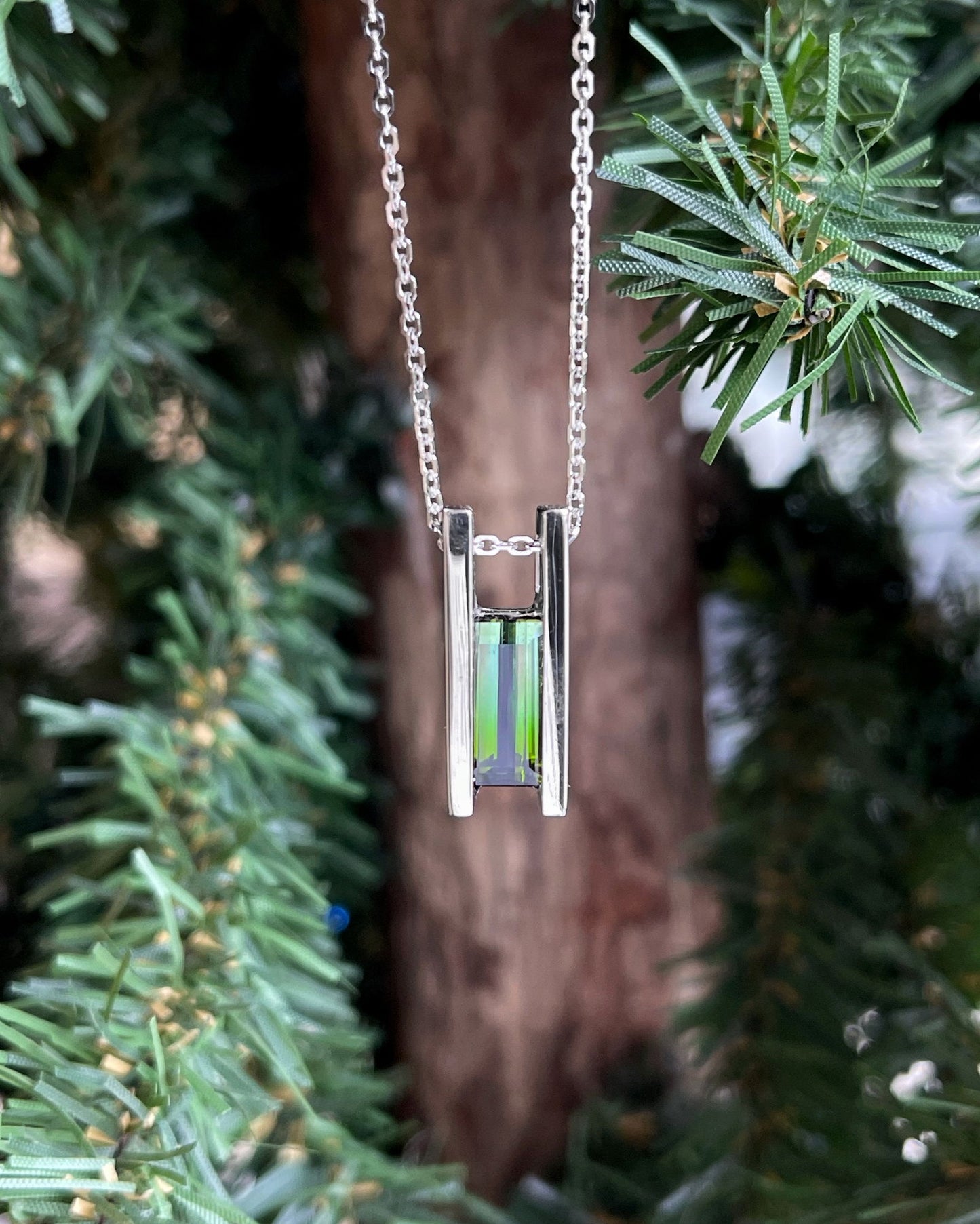 Photo of Ombre Tourmaline Pendant in a decorative scene, designed by , available at Plumb Gold & Plumb Silver