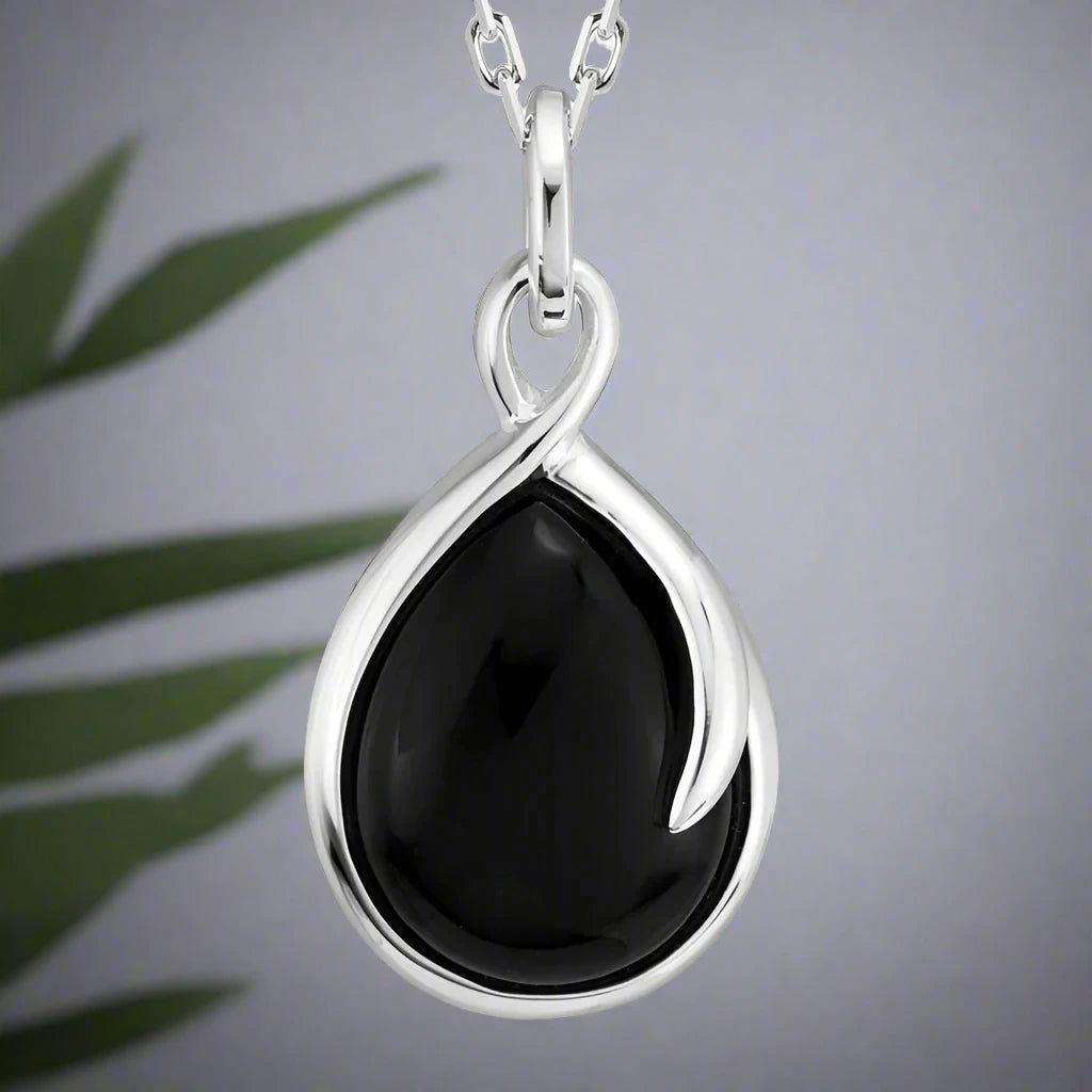 Photo of Onyx "Wish" Necklace in a decorative scene, designed by , available at Plumb Gold & Plumb Silver