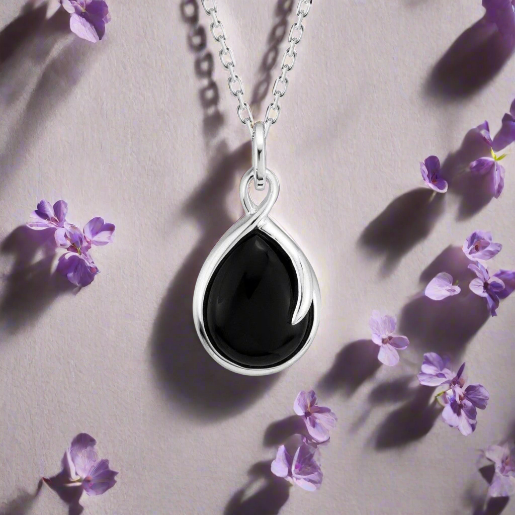 Photo of Onyx "Wish" Necklace in a decorative scene, designed by , available at Plumb Gold & Plumb Silver