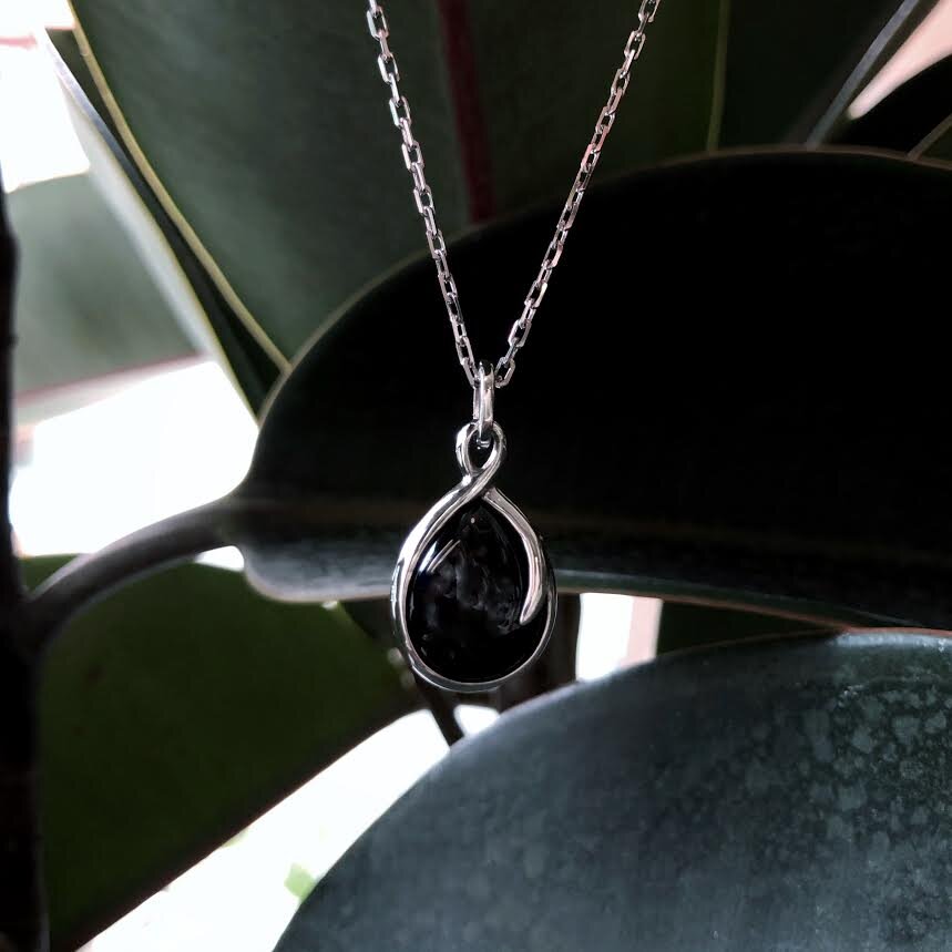 Photo of Onyx "Wish" Necklace in a decorative scene, designed by , available at Plumb Gold & Plumb Silver