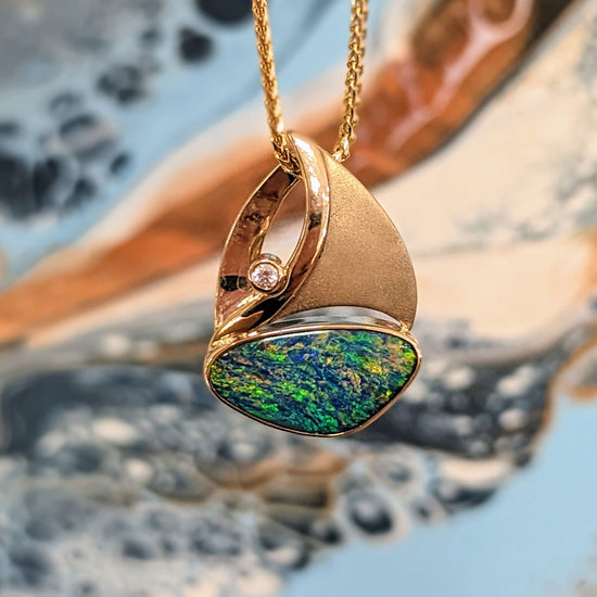 Photo of Opal Sailboat with Diamond Accent in a decorative scene, designed by , available at Plumb Gold & Plumb Silver