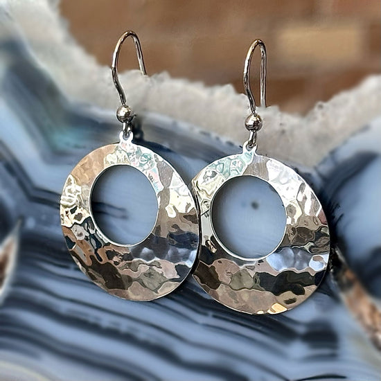 Photo of Open Circle Dangles in a decorative scene, designed by , available at Plumb Gold & Plumb Silver