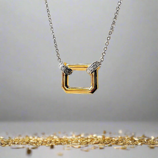 Photo of Open Shape Necklace in a decorative scene, designed by , available at Plumb Gold & Plumb Silver