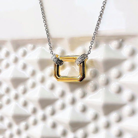 Photo of Open Shape Necklace in a decorative scene, designed by , available at Plumb Gold & Plumb Silver