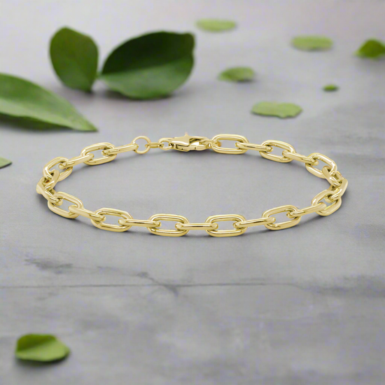 Photo of Oval Cable Bracelet in a decorative scene, designed by , available at Plumb Gold & Plumb Silver